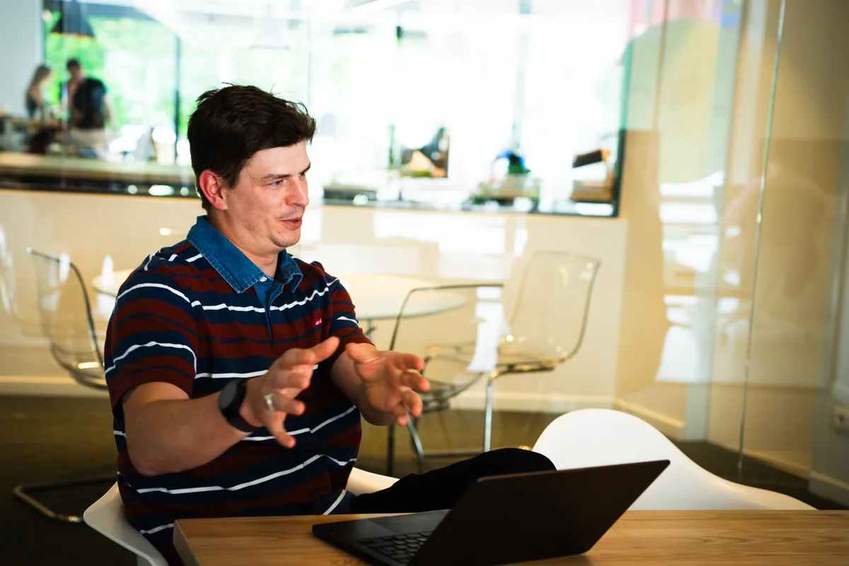 Someone talking an idea through at a laptop