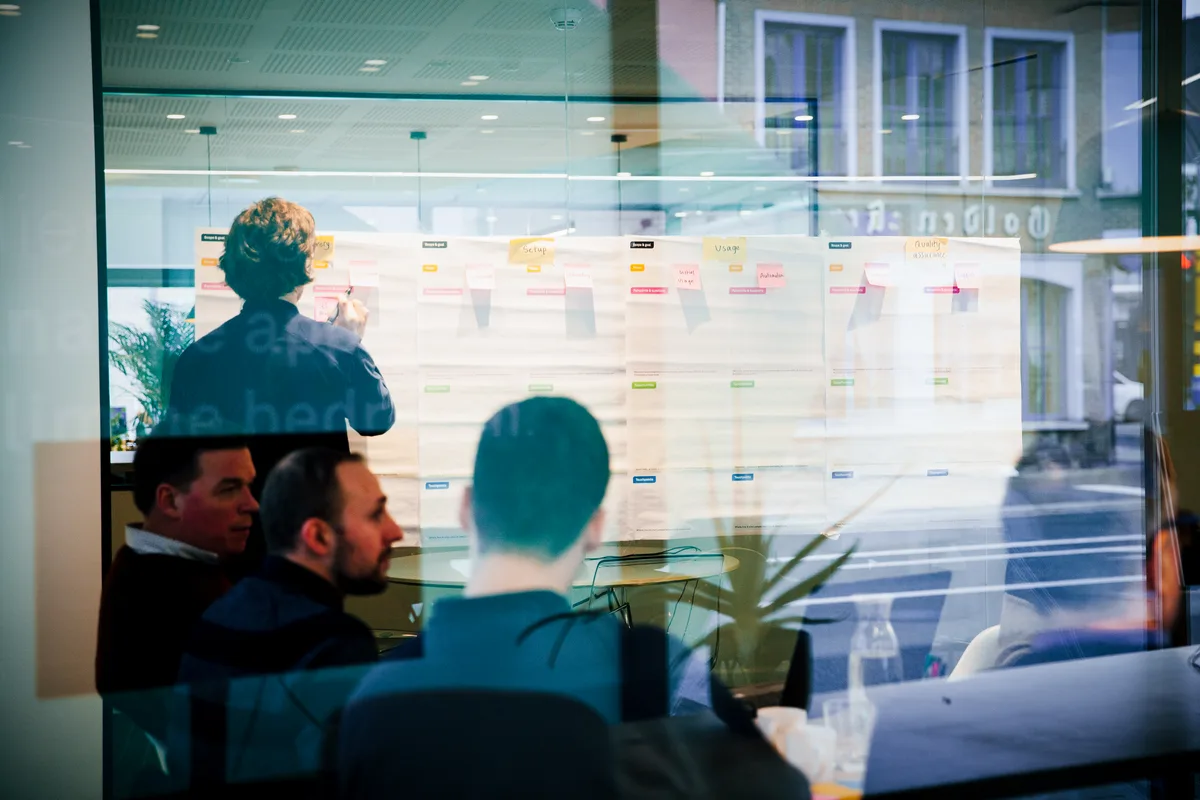 A team mapping out a user journey on sticky notes